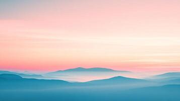 Serene mountain range landscape with a gradient pink and orange sky, casting a cool, ethereal blue over the peaks, creating a tranquil scene. photo
