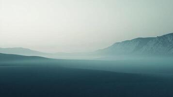 Hazy mountain landscape with soft blues and greens, serene and minimalist, evoking a sense of peace and tranquility in nature. photo