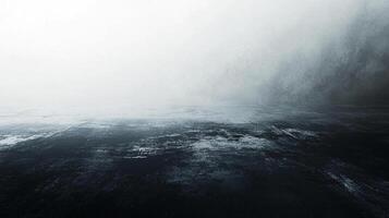 Monochromatic abstract image with a vast, dark ocean and sky merging in a hazy, atmospheric scene, evoking tranquility and depth. photo