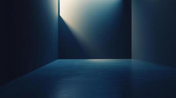 Illuminated minimalist space featuring concrete floor with a dark blue tone, with the only light source coming from a window slit. photo
