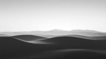 Monochromatic hills cascade into the distance under a soft sky, creating a serene and ethereal landscape. The scene evokes peace and solitude. photo