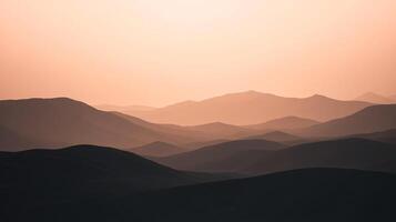 Serene mountain ranges layered under a soft, hazy light create a peaceful landscape. The varying shades add depth and beauty. photo