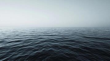 Calm ocean view with subtle ripples and a clear horizon. Deep blues and light sky create a serene, minimalist seascape for relaxation. photo