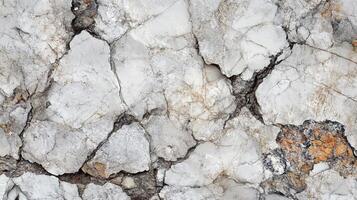 Detailed rock face texture featuring cracks, subtle color variations, and intricate surface details. Geological textures abound in this shot. photo