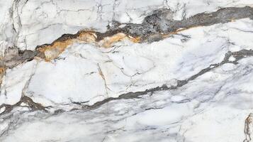 Intricate marble texture featuring white, grey, and gold veining patterns, adding a luxurious touch to surfaces and interior designs. photo