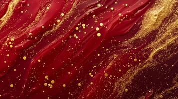 Abstract texture of flowing deep red liquid with trails of sparkling golden glitter and dots scattered throughout the artistic design. photo