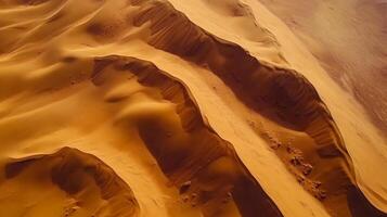 Aerial view of a vast desert landscape showcasing the undulating patterns of sand dunes under the warm light, perfect for backgrounds. photo