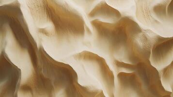 Serene sand dunes with rolling beige waves of sand, casting subtle shadows that create a tranquil and natural pattern. photo
