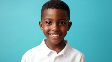 Portrait of a smiling boy with a kind expression, set against a vibrant teal background, showcasing youthful joy and innocence. photo