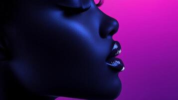 A closeup of a person's face in profile, bathed in vibrant blue and purple light, emphasizing facial features and shiny lips. photo