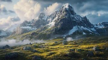 Majestic snow-capped peaks rise above a lush green valley, shrouded in mist and illuminated by the gentle glow of sunlight under cloudy skies. photo