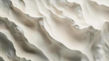 Aerial view of smooth, flowing sand dunes, showcasing their natural, undulating formations. Light and shadows create texture. photo