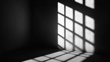 Sunlight streams through a gridded window onto an empty room's corner, casting geometric shadows, creating a minimalist, contrasting scene. photo