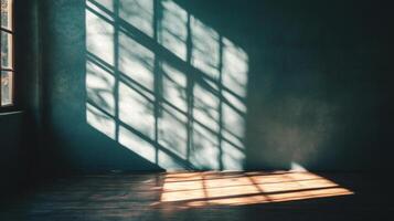 Window light and shadows cast geometric shapes across a textured wall and wooden floor creating a moody, minimalist interior scene. photo