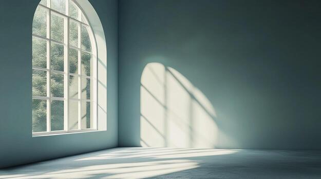 Sunlight streams through an arched window illuminating an empty room with soft, diffused light, creating a serene and minimalist atmosphere. photo