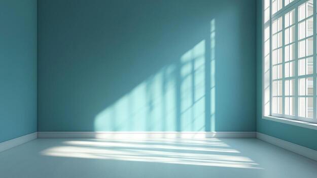 Sunlight streams into an empty room with teal walls, casting shadows from a large window, creating a bright and airy space. photo