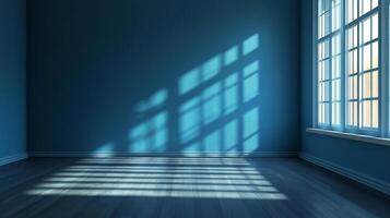 An empty, bright, blue-toned room features window light creating interesting shadow patterns on the floor and wall creating artistic scene. photo