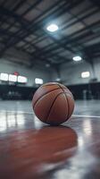 basketball rests on polished floor of indoor gym, inviting play photo