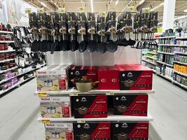 Lviv, Ukraine - February 16, 2025 Kitchenware display with pots, utensils, and cooking accessories in a supermarket aisle photo