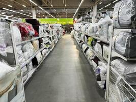 Lviv, Ukraine - February 16, 2025 Warehouse shelves lined with bedding products in a brightly lit retail store photo