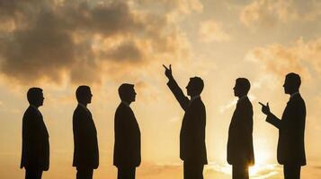 Silhouetted Business Team Against a Golden Sunset A Powerful Image Representing Leadership, Success, and Collaboration in the Corporate World Explore the Symbolism of Unity, Strategy, and Achievement photo