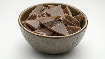Delicious Homemade Toffee Candy Pieces in a Rustic Ceramic Bowl, a Sweet Treat for Any Occasion Capture the Rich Flavors of Buttery Caramel and Crunchy Nuts in This Mouthwatering Still Life photo