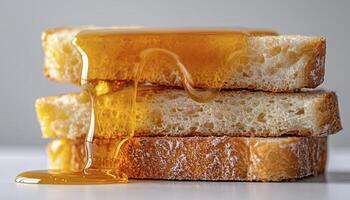 Delicious Stack of Honey Drizzled Bread Slices A Close-Up View of Golden Syrup Cascading Over Freshly Baked Bread Perfect for Breakfast, Brunch, or a Sweet Treat, This Image Captures the Warmth and photo