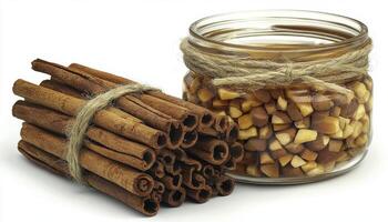Discover the aromatic allure of cinnamon sticks and a jar filled with delightful cinnamon pieces, captured in a stunning still life Immerse yourself in the warm, inviting essence of this iconic photo