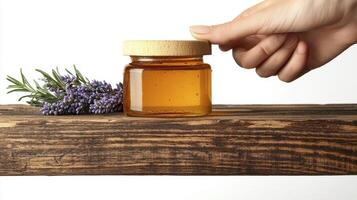 Golden Honey Jar Still Life Capturing the Sweetness of Nature with Lavender Accent A rustic wooden board as a surface for a natural healthy food ingredient that provides energy and healing properties photo
