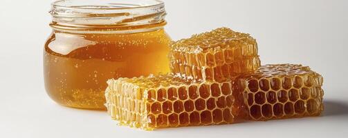 Golden Honeycomb and Jar of Honey A Natural Sweet Treat, perfect for breakfast or a healthy snack This image shows the beauty of nature's nectar, with golden hues and intricate honeycomb structures photo