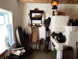 Traditional rural kitchen with utensils and decorative cloths in a rustic setting photo