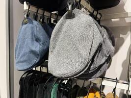 Close-up of stylish flat caps displayed on a retail store shelf photo