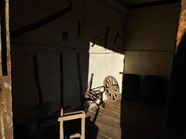 Vintage tools and wooden items illuminated by sunlight in a rustic interior photo