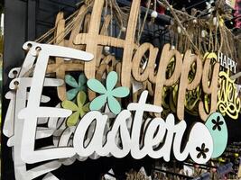 Decorative hanging sign with Happy Easter text and spring floral theme photo