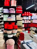 Shelves of colorful gift boxes and containers arranged neatly in a shop. photo