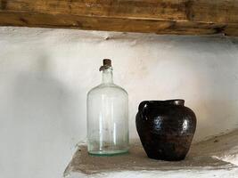 Rustic Vintage Bottles and Pitcher Set Against a Simple White Background photo