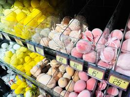 Colorful Bath Bombs Displayed in Transparent Containers on a Store Shelf photo