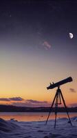 telescope on tripod overlooks snowy landscape at sunset, with crescent moon in sky photo