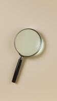magnifying glass on beige background, showcasing its simple and minimal design. Perfect for enhancing details and clarity photo