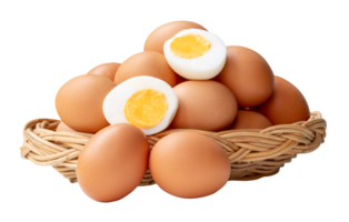 Raw brown chicken eggs and peeled cooked or boiled eggs with egg yolk in two halves in stack in wicker basket isolated with clipping path in file format png