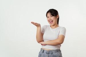Confident cheerful woman is spreading her hands out on an empty space to present some products. photo