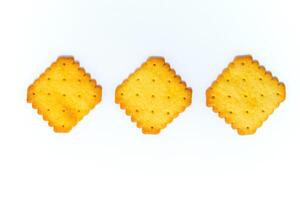 Three biscuit crackers in a square shape on a white background photo
