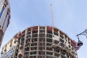View of a building under construction with a crane on top photo