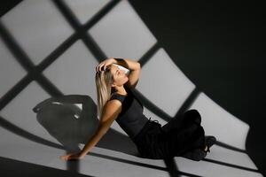 Young dancer performing with window-shaped shades on background photo