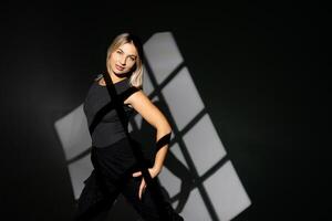 Young dancer performing with window-shaped shades on background. photo