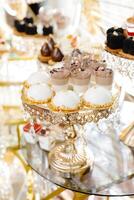 Delicious macarons and pastries decorating a luxurious candy bar buffet photo