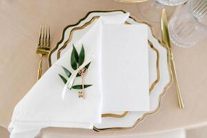 Elegant Place Setting with Gold Key and Blank Card on White Plate photo