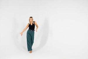 Young blonde woman gesturing with hands on white background. photo