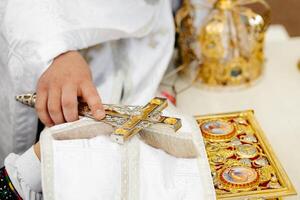 Priest holding a cross during a religious ceremony photo