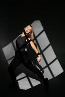 Dancer performing with window-shaped shades on background. photo